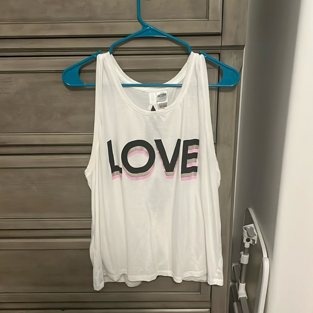 Two different Victoria Sport size large tank tops.  1 is white, 1 is blue
